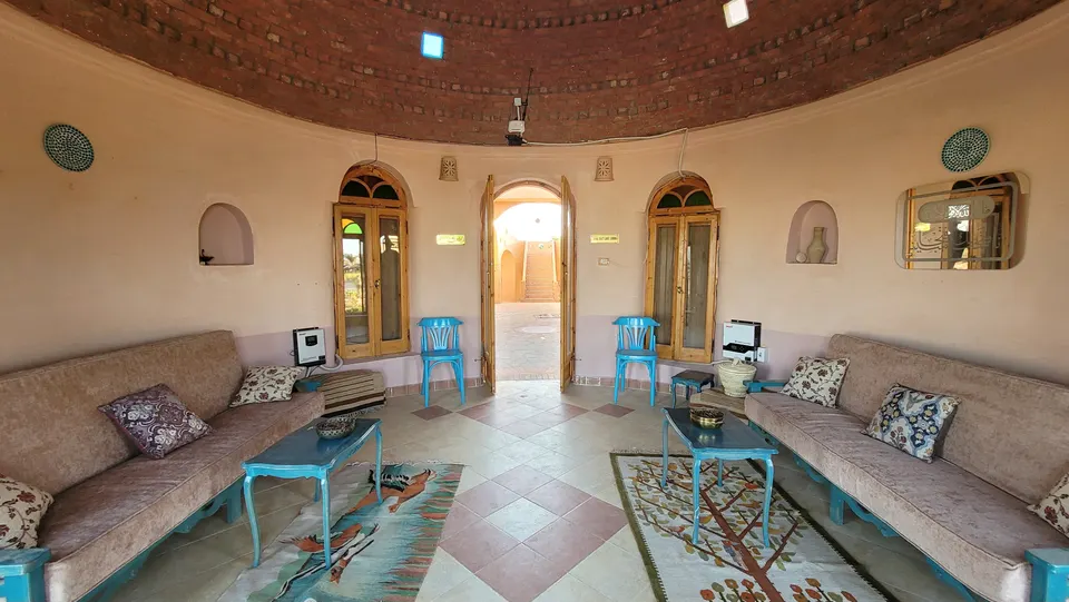 A circular lounge with a brick dome and built-in seating