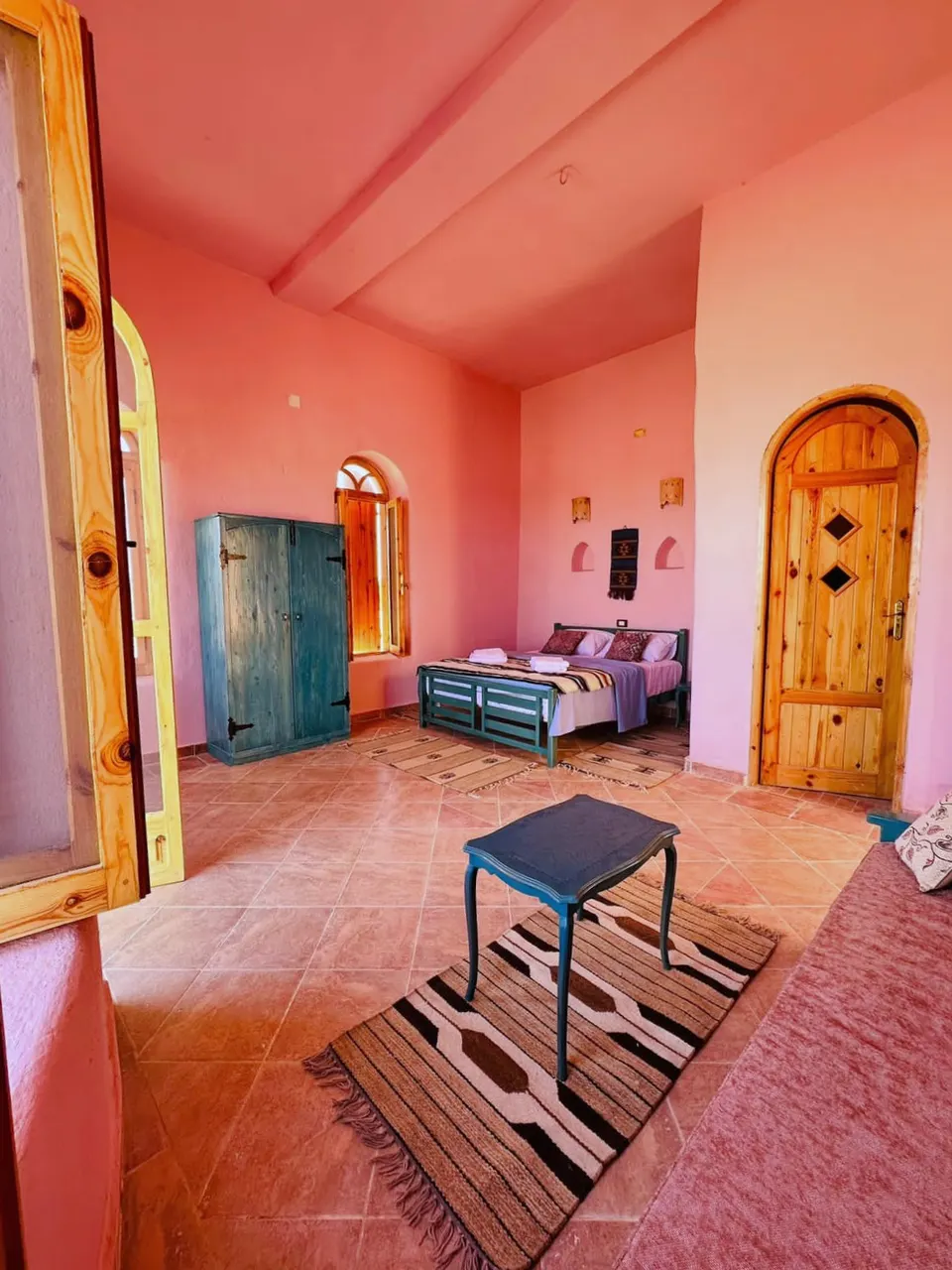 A view across the room with warm wall colours · Suite
