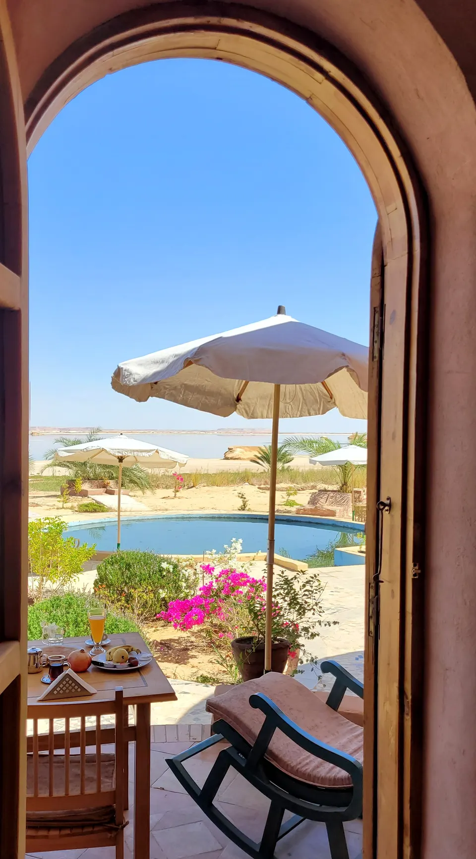 A view through the arched doorway towards the terrace · Suite