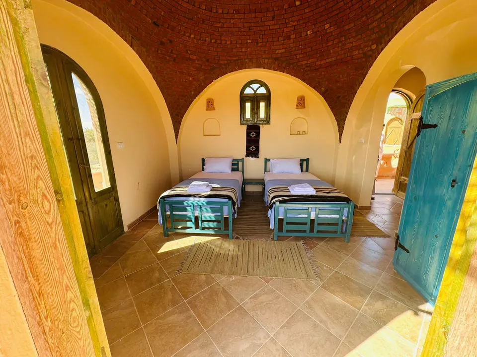 A view through the doorway towards the beds · Panorama