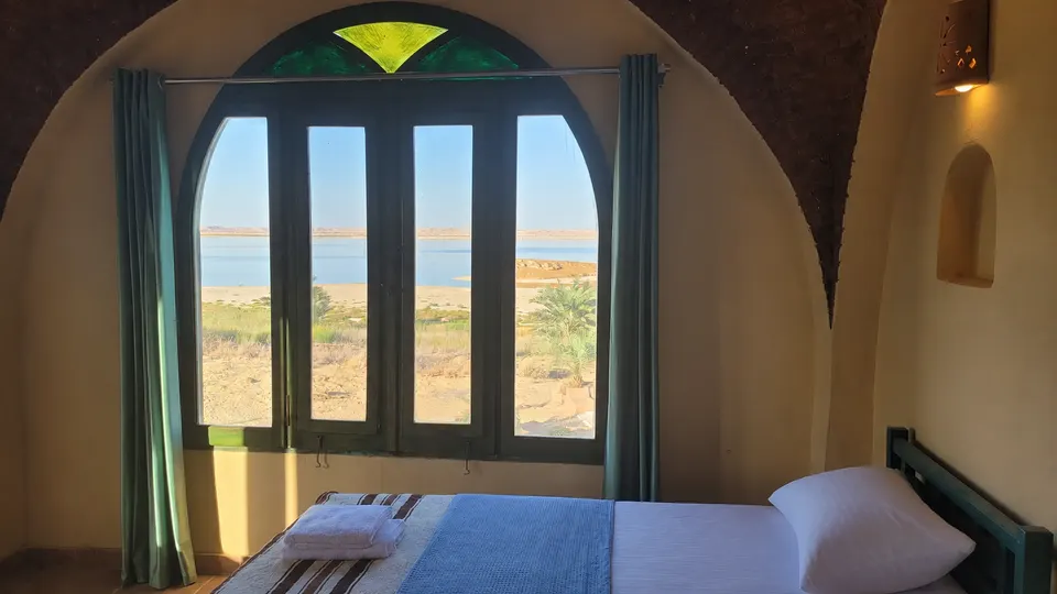 An arched window looking towards the lake · Panorama