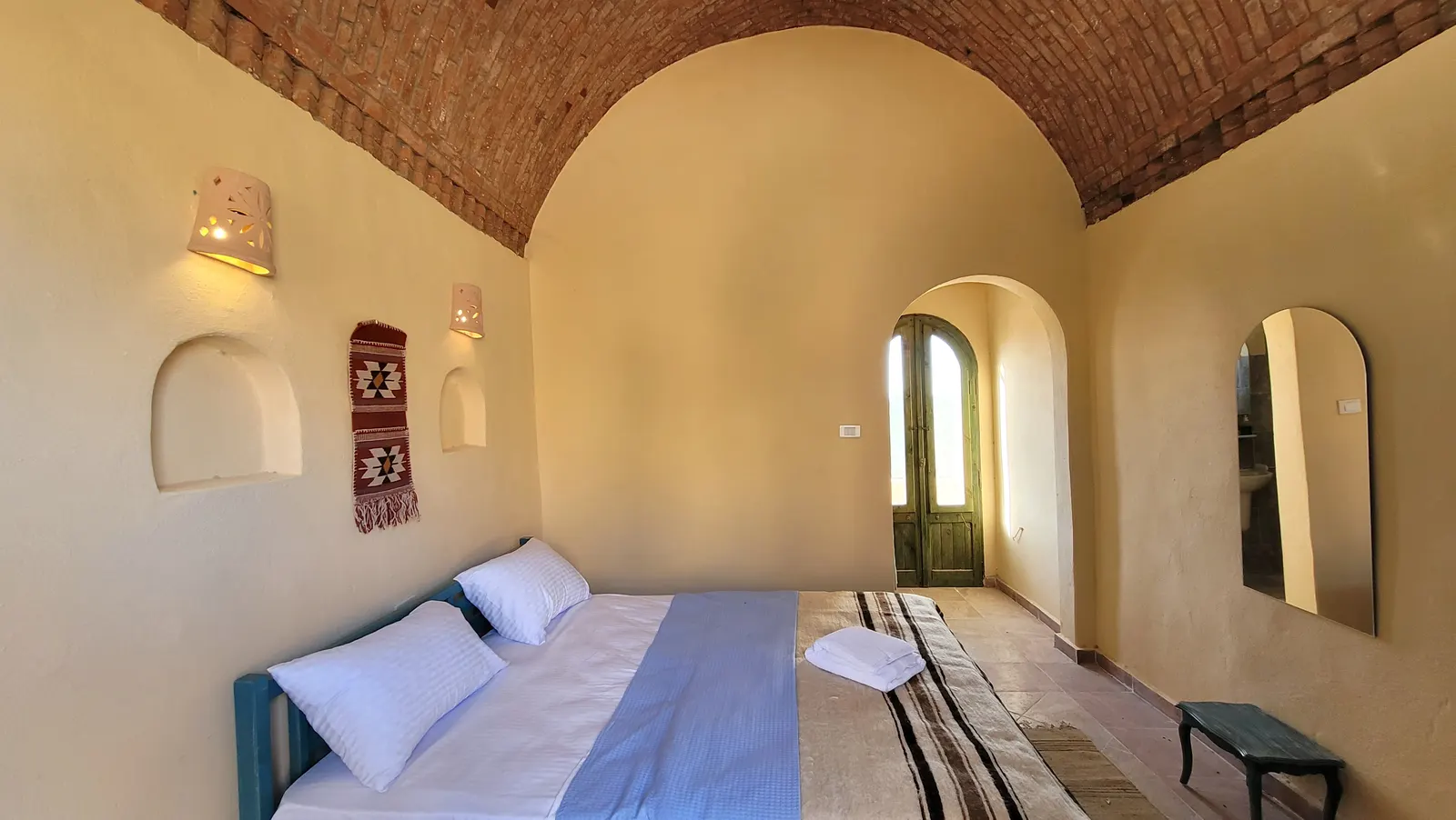 Beds beneath a vaulted brick ceiling · Standard