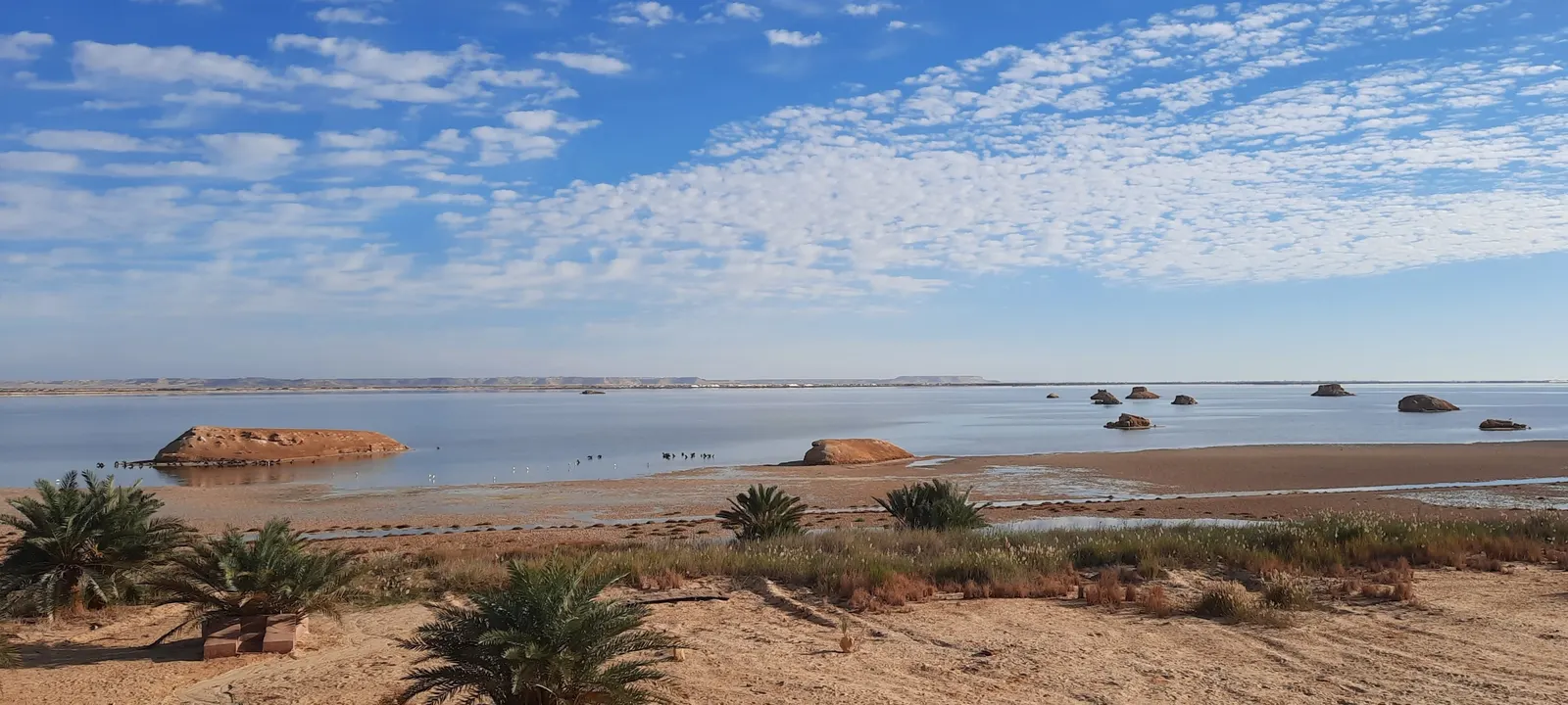 Clouds above the lake and small islands in front of the lodge