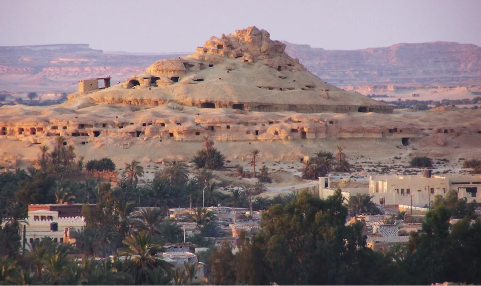 Rock-cut tomb entrances on the Mountain of the Dead above Siwa.