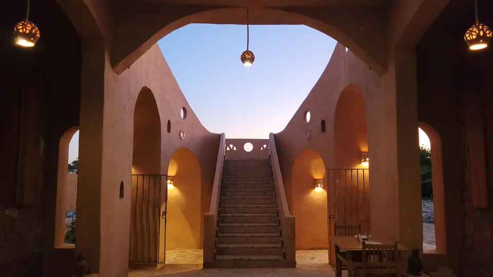 The illuminated courtyard seen through an archway