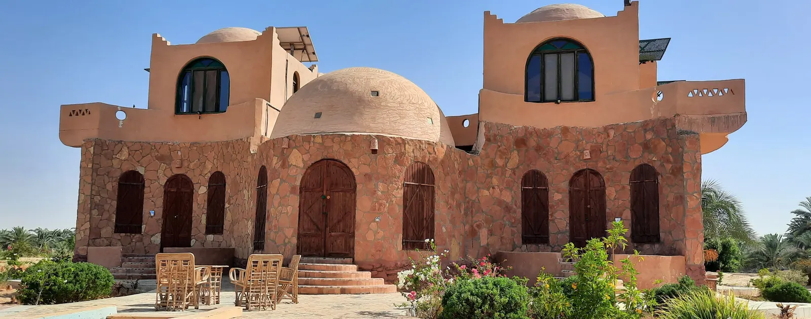 The lodge entrance with sand-coloured walls and domes